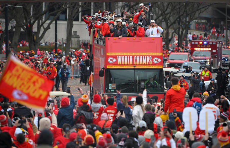 Barricades held fans back as double-decker buses carried the members of the Kansas City Chiefs including tight end Travis Kelce, upper, right, on their Super Bowl LVII victory parade to Union Station Wednesday, Feb. 15, 2023, in Kansas City.