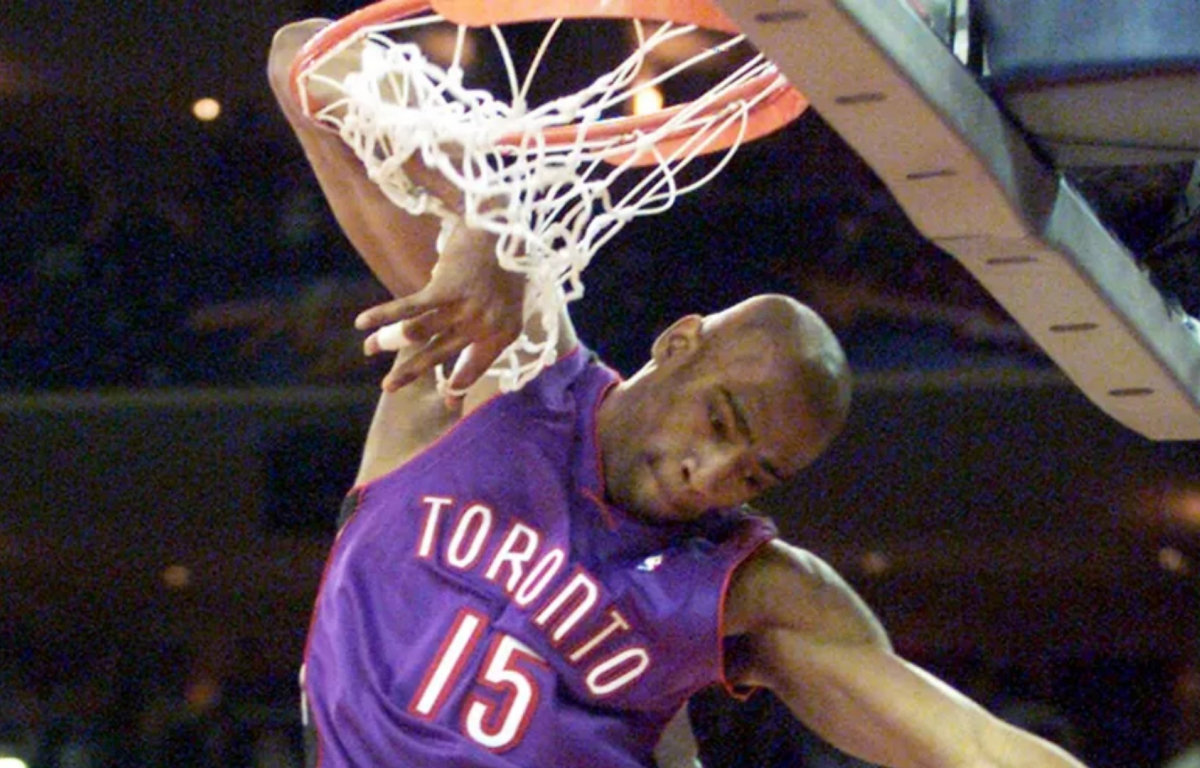 <p>Vince Carter elevated with unmatched athleticism, gracefully bringing the ball behind his head and throwing down a powerful dunk while his elbow hung on the rim, leaving the crowd in awe.</p>