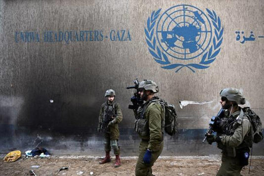 Israeli soldiers operate next to the UNRWA headquarters amid the ongoing conflict between Israel and the Palestinian Islamist group Hamas in the Gaza Strip on February 8, 2024. 