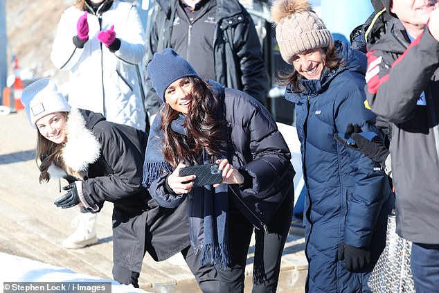 meghan markle wraps up in £3,000 hermes puffer jacket and dons £150,000 of jewellery (including her re-set engagement ring) to cheer on prince harry at the track in whistler