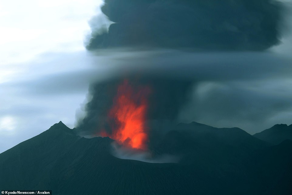 Japan volcano erupts sending ash cloud into air and launching boulders