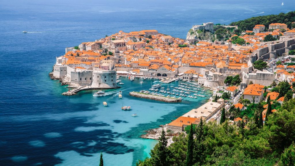 <p>Fondly referred to as the Pearl of the Adriatic, Dubrovnik is the place to indulge in picturesque beaches perfectly co-existing with medieval history.  Located just outside Dubrovnik, Banje Beach offers crystal-clear waters, peddled shores, and a vibrant beach ambiance. Catch up-close views of the city’s ancient walls while at Banje Beach.</p><p> Lying below a cliff, the secluded Sveti Jakov Beach is best for a tranquil retreat, panoramic views of the Adriatic Sea, and swimming in its turquoise waters.  Wind up your summer trip to Dubrovnik by visiting the city’s old town, a UNESCO World Heritage site. You may also take a scenic ride on the Dubrovnik Cable Car to Mount Srđ for panoramic views of the city, surrounding islands, and the Adriatic Sea.</p><p class="has-text-align-center has-medium-font-size">Read also: <a href="https://worldwildschooling.com/hidden-european-islands/">Hidden European Islands</a></p>