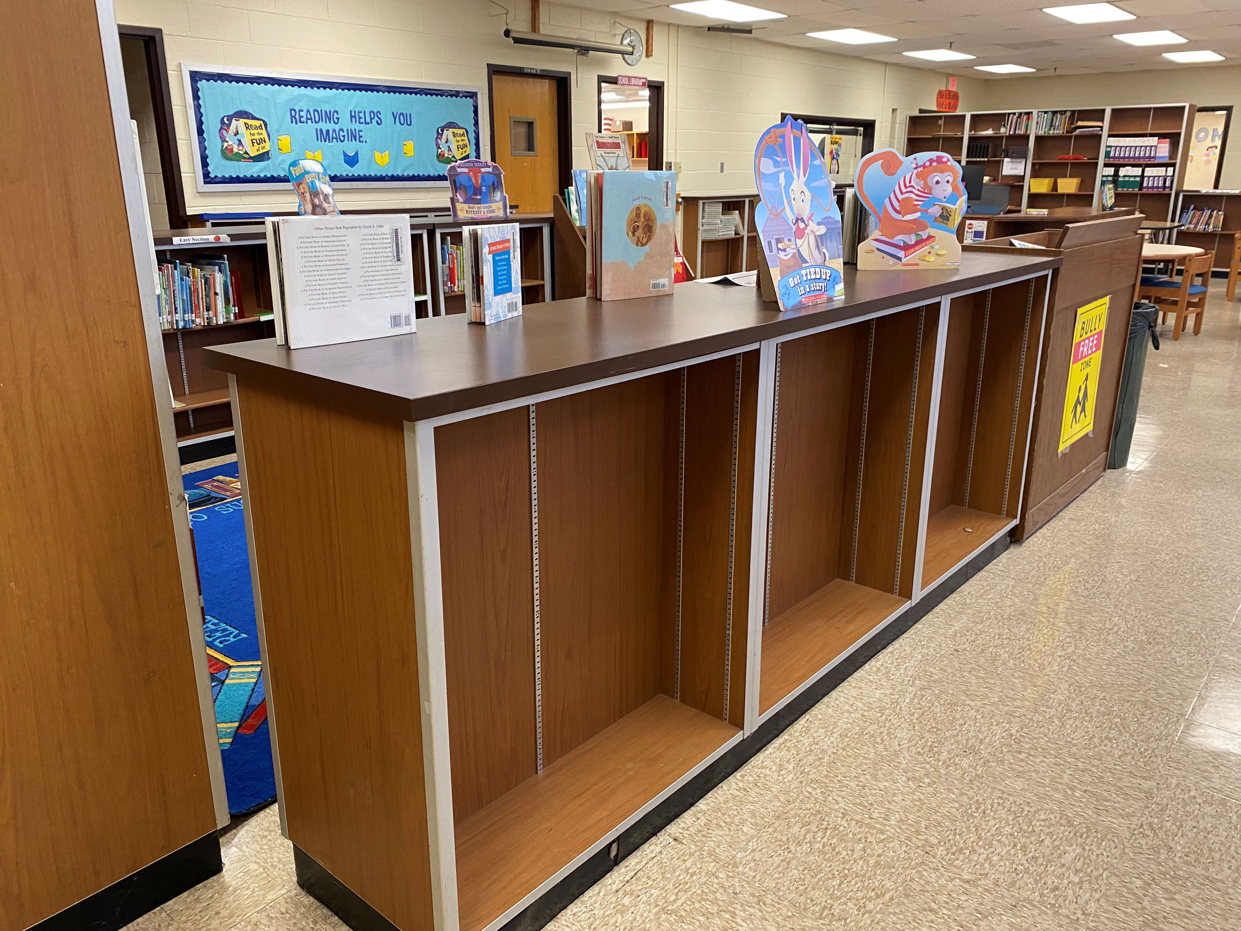 in a maryland school library, empty shelves are about to get emptier