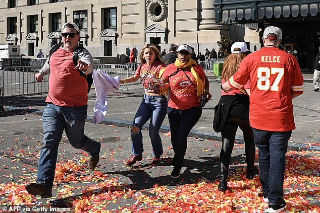 kansas city chiefs parade shooting suspects are captured in heated exchange moments before gunfight killed one and injured 22 others - as teen is seen walking away clutching his bloody face