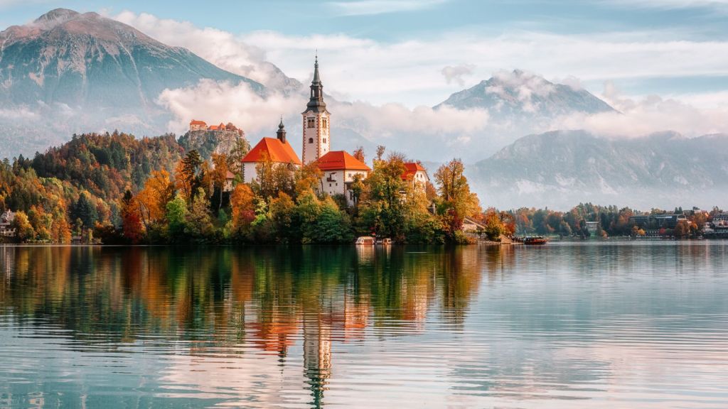 <p>The magical setting by deep emerald Lake Bled instantly charms anyone arriving in this small Slovenian town. Then you spot the tiny island at the center of the lake, complete with a charming little church. Bled Castle also overlooks the town, backed by the beautiful Julian Alps. The scent of freshly baked pastries and the sight of colorful floral displays only adds to Bled’s fairytale appeal.</p><p class="has-text-align-center has-medium-font-size">Read also: <a href="https://worldwildschooling.com/unique-places-for-your-european-bucket-list/">Unique Places for Your European Bucket List</a></p>