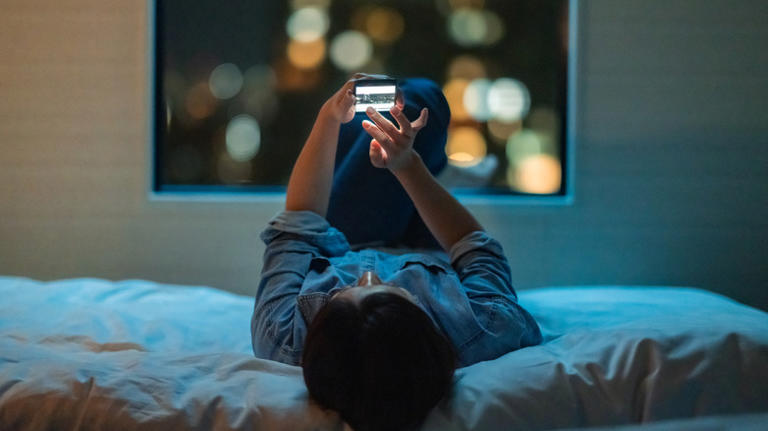 Person on their phone in bed