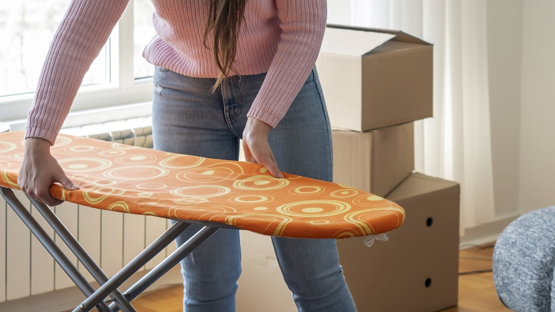 the ironing board hack that'll save your back when working under the sink