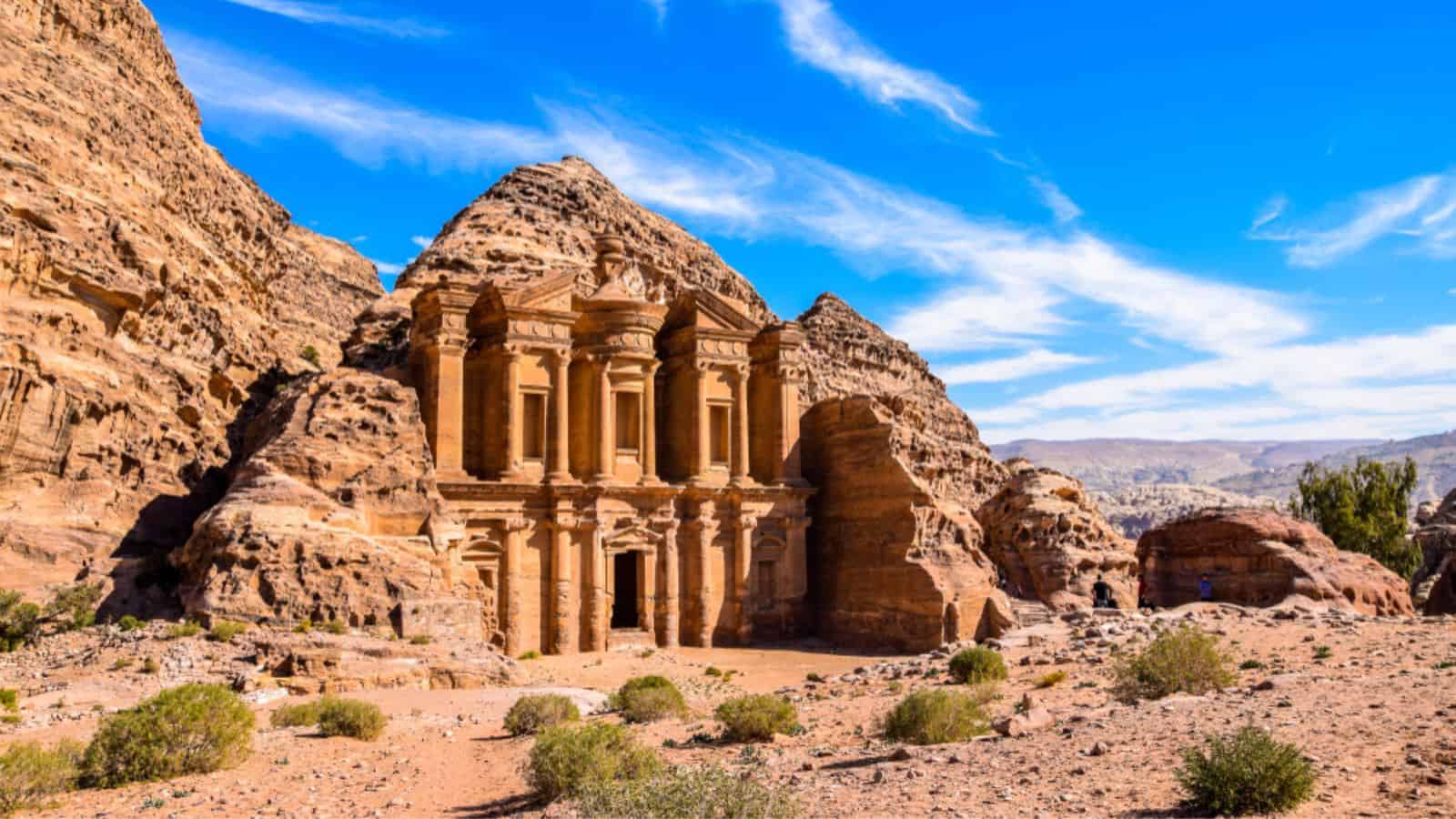 <p><a href="https://www.businessinsider.com/petra-jordan-7-wonders-of-the-world-indiana-jones-2018-7?r=US&IR=T#:~:text=The%20ancient%20city%20of%20Petra,The%20Last%20Crusade%20in%201989.">Business Insider</a> reports that this 10,000-year-old city carved directly into red sandstone cliffs is one of the newest wonders of the world. Petra was once the thriving capital of the Nabataean Kingdom and is now an archaeological wonder, famed for its intricate façades, ingenious water conduit system, and its blend of Eastern and Hellenistic architectural styles.</p>