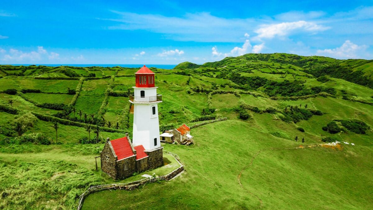 <p>Batanes sits at the northern tip of the Philippines and is a romantic paradise for couples seeking adventure and serenity. Its dramatic landscapes of rolling hills, rugged cliffs, and vast ocean views create a naturally romantic setting. </p><p>The serenity here is unmatched, with the gentle hum of the wind and the sight of wild horses galloping across open fields. </p><p>Within this archipelago, only the Batan, Itbayat, and Sabtang islands are inhabited, offering a blend of breathtaking natural wonders and rich cultural experiences. </p><p>A visit to North Batan could include a day exploring the iconic Basco Lighthouse and the mesmerizing Vayang Rolling Hills. The extraordinary Valugan Boulder Beach, with its shoreline covered in rounded boulders, is a sight to behold. </p><p>South Batan reveals the majestic views of Marlboro Country, while Sabtang invites couples to step back in time with its centuries-old Ivatan stone houses. </p>