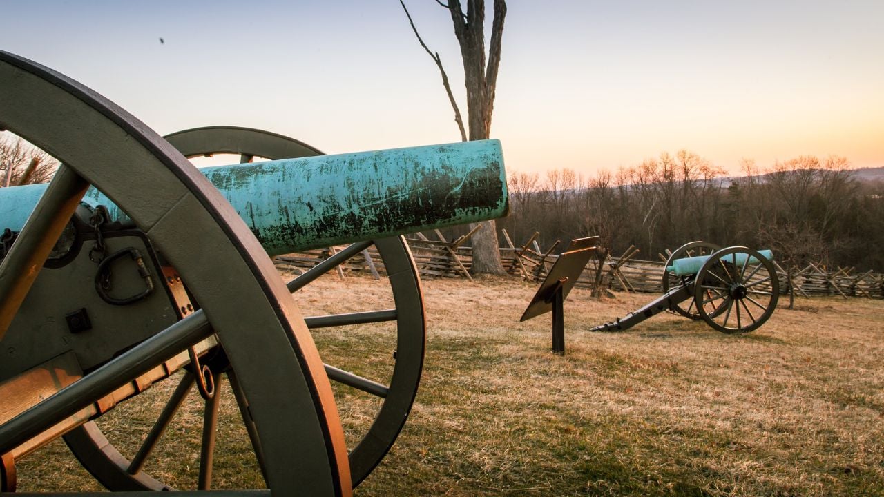 <p><a href="https://www.hotelgettysburg.com/2018/09/the-haunted-history-of-gettysburg/#:~:text=The%20Gettysburg%20Battlefield&text=What%20is%20now%20the%20Gettysburg,that%20time%20has%20moved%20on." rel="nofollow noopener">Gettysburg Battlefield</a>–a land soaked in blood–where the choreography of the Civil War’s deadliest dance continues to perform. The ground itself is scarred by the conflict and seems to hold onto the souls of the fallen. You can almost hear the clashing of steel and the cries of the doomed hitting the ground around you. </p><p>A rock formation known as “Devil’s Den” watches over the battlefield. Its name is a grim testimony to the horrors it witnessed. You may bump into various ghostly apparitions or a figure offering silent guidance with its words lost to time. The shadows of three betrayed soldiers at Sachs Bridge play out their final moments. Every twist and turn of the place indicates that some stories are too tragic to ever truly end.</p>