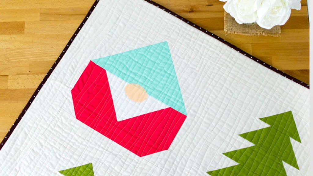 <p>This <a href="https://www.sewcanshe.com/blog/2018/12/11/sew-a-gnome-quilt-free-block-pattern" rel="noreferrer noopener">Gnome Forest Quilt Pattern</a> is a fat-quarter friendly holiday quilt pattern that is perfect for any time of year. There are 12” quilt blocks made up of flying geese, rectangles, and snowball corners, with a single appliqué for the nose. Learn easy tricks for making flying geese units, how to use the snowball corner method to make the gnome bottom, and how to assemble the entire quilt. The pattern only has a few blocks, but you could easily make more blocks to make a quilt as large as you’d like!</p>
