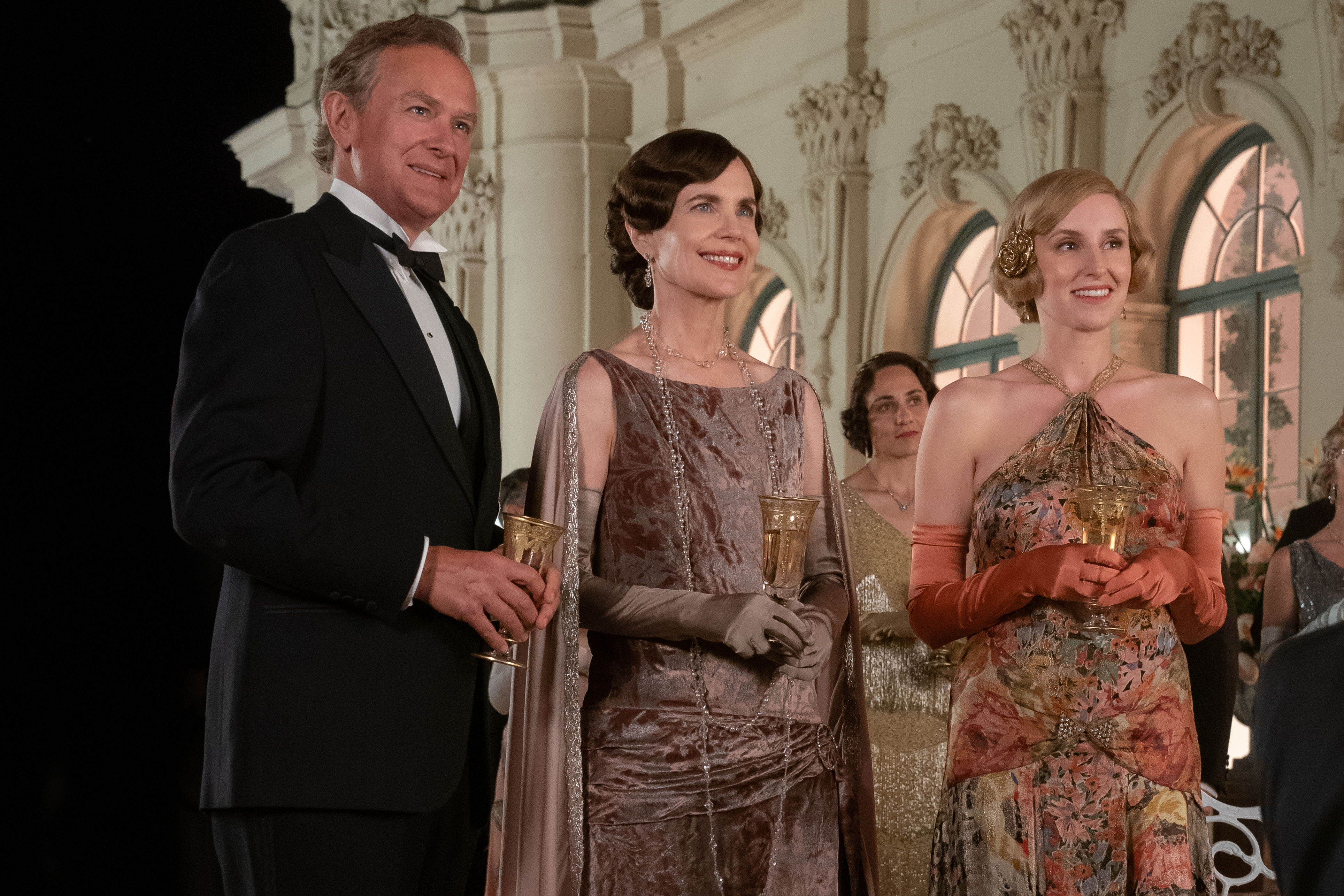 <p>Robert Crawley, the Earl of Grantham (played by Hugh Bonneville) suited up in a tuxedo while wife <span>Cora Crawley, Countess of Grantham (played by Elizabeth McGovern) wore a crushed velvet dress with a satin cape and middle daughter Edith Pelham, Marchioness of Hexham (played by Laura Carmichael) donned a halter-style floral gown and satin gloves in the 2022 film "Downton Abbey: A New Era</span>," which is set in 1928 at the tail end of the Roaring '20s before the Great Depression begins.</p><p>MORE: <a href="https://www.wonderwall.com/style/fashion/best-period-costumes-all-time-tv-movies-3011841.gallery">The best period series and movie costumes of all time</a></p>