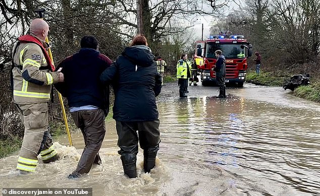 'i couldn't leave the guy': hero who saved trapped driving instructor from sinking car reveals 'shock' after firefighter seen leaning on fence while vehicle was submerged in 4ft of floodwater 'walked away'