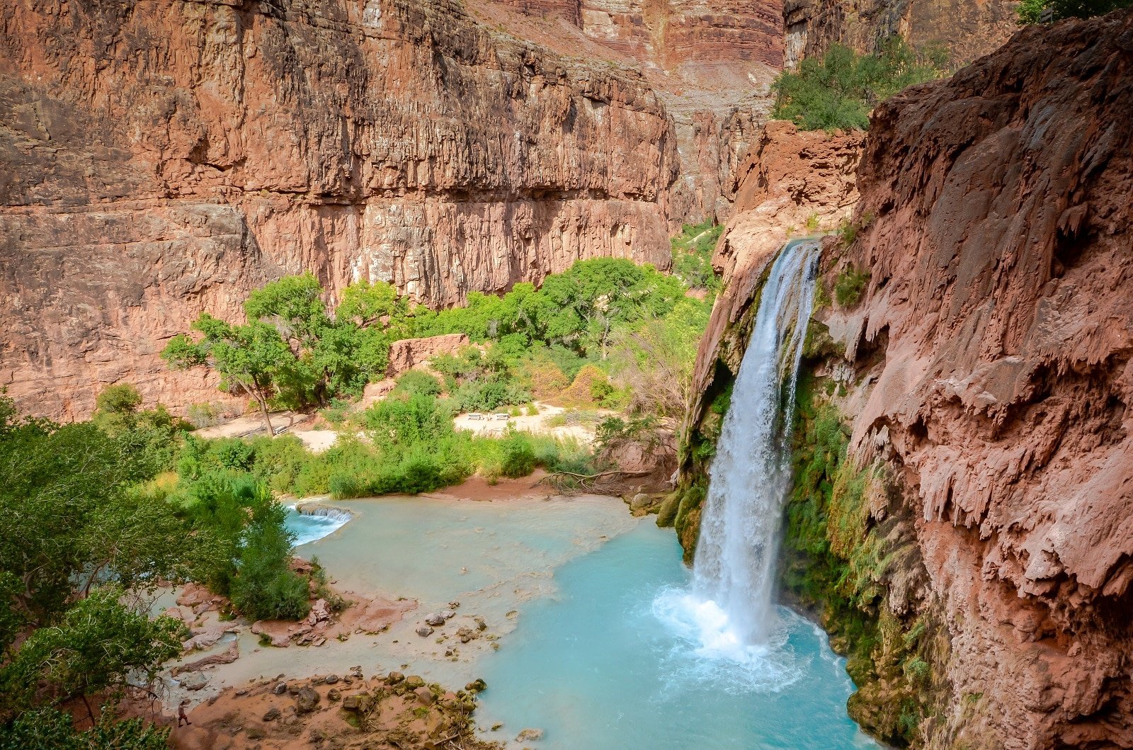 <p><span>Immerse yourself in the stunning beauty of Havasu Falls in the Grand Canyon, known for its vibrant blue-green waters set against red canyon walls. Part of the Havasupai Indian Reservation, this secluded waterfall offers a tranquil paradise for swimming and relaxation. The hike to Havasu Falls is challenging but rewarding, with several smaller waterfalls along the way. Be sure to plan and reserve your trip well in advance due to limited access and high demand.</span></p> <p><b>Insider’s Tip: </b><span>Make reservations well in advance as access is limited. </span></p> <p><b>When To Travel: </b><span>Spring and fall for ideal hiking conditions. </span></p> <p><b>How To Get There: </b><span>Hike from Hualapai Hilltop, which is reachable by car.</span></p>