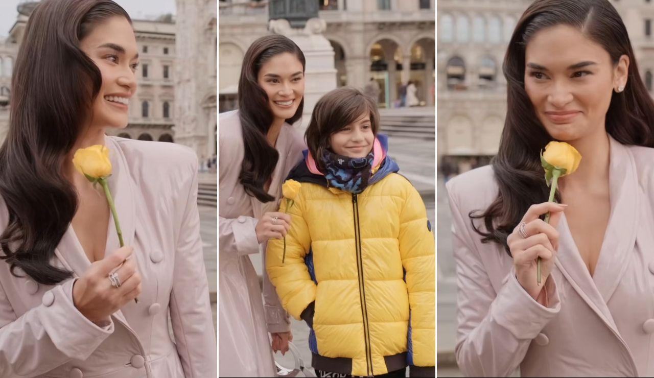a boy in milan gives pia wurtzbach a rose and she can't stop smiling