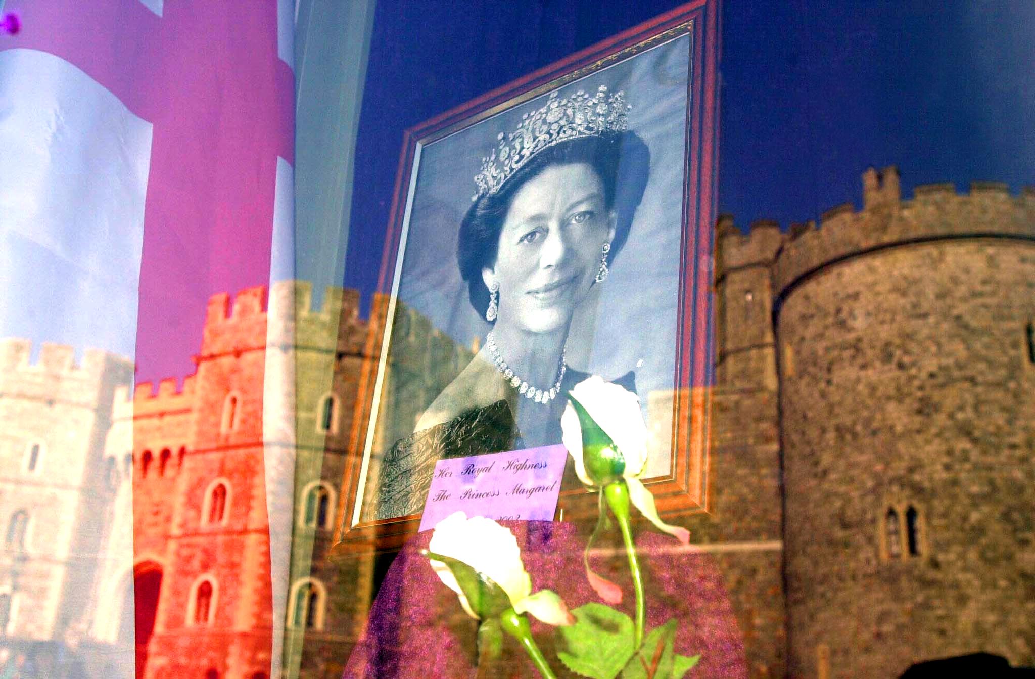 <p><span>A portrait of Princess Margaret hung in a gift shop behind a reflection of Windsor Castle, where her funeral service was held on Feb. 15, 2002. Margaret died at 71 on Feb. 9 -- three days after the 50th anniversary of her father's death -- at King Edward VII's Hospital in London following a stroke.</span></p>