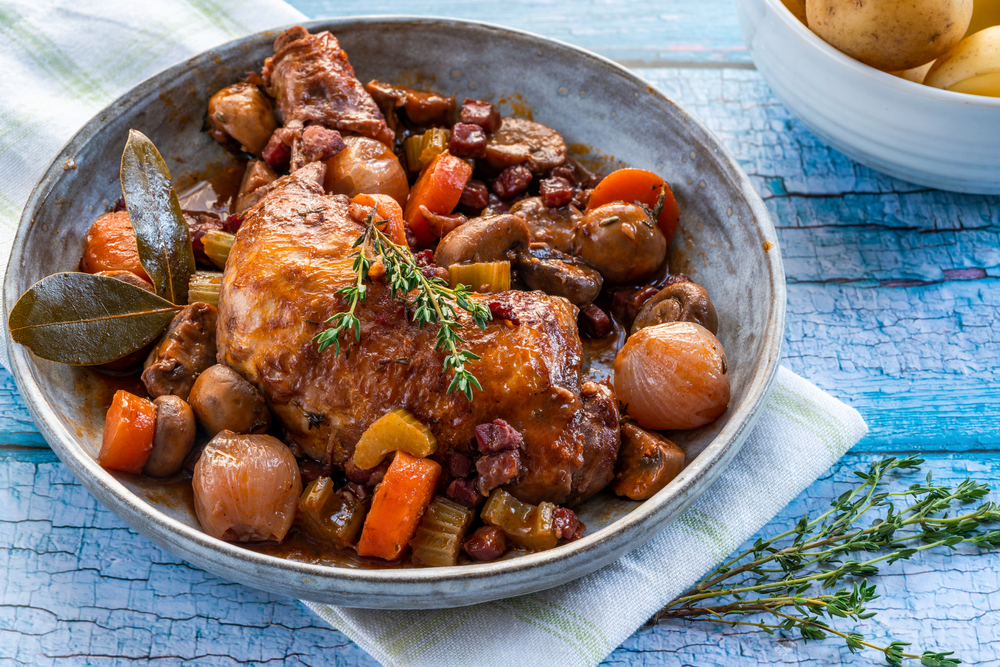 <p>Coq au Vin is a celebration of French rural tradition. This dish, which translates to “<em>rooster in wine</em>,” is a hearty stew where chicken is slowly braised with wine, mushrooms, salt pork, and garlic. Originating from the Burgundy region, known for its exceptional wine and produce, Coq au Vin exemplifies the French approach to cooking: transforming basic ingredients into a dish with deep, complex flavors.</p>