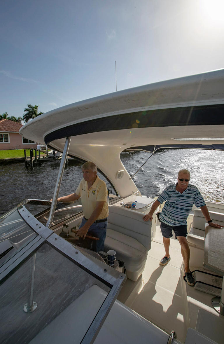 Cape Coral Cruise Club Commodore Bill Peterson navigates his boat through the Plato canal in Cape Coral along with club membership chairman Terry Carlson. The club, celebrating its 60th anniversary next year, puts on regular trips for its members.