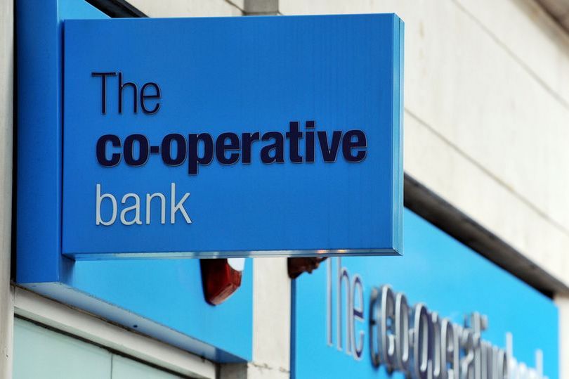the co-operative bank's profit hit by one-off costs as takeover talks move ahead