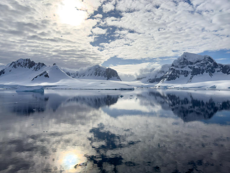 Reflections on the water inside paradise bay in antarctica