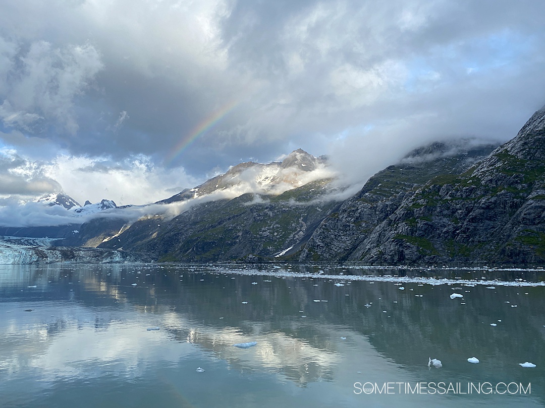 Rainbow over a snow-capped mountain in Glacier Bay, Alaska.