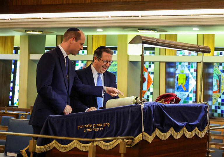 Rabbi Daniel Epstein shows Prince William a 17th century Torah scroll (Picture: Reuters)