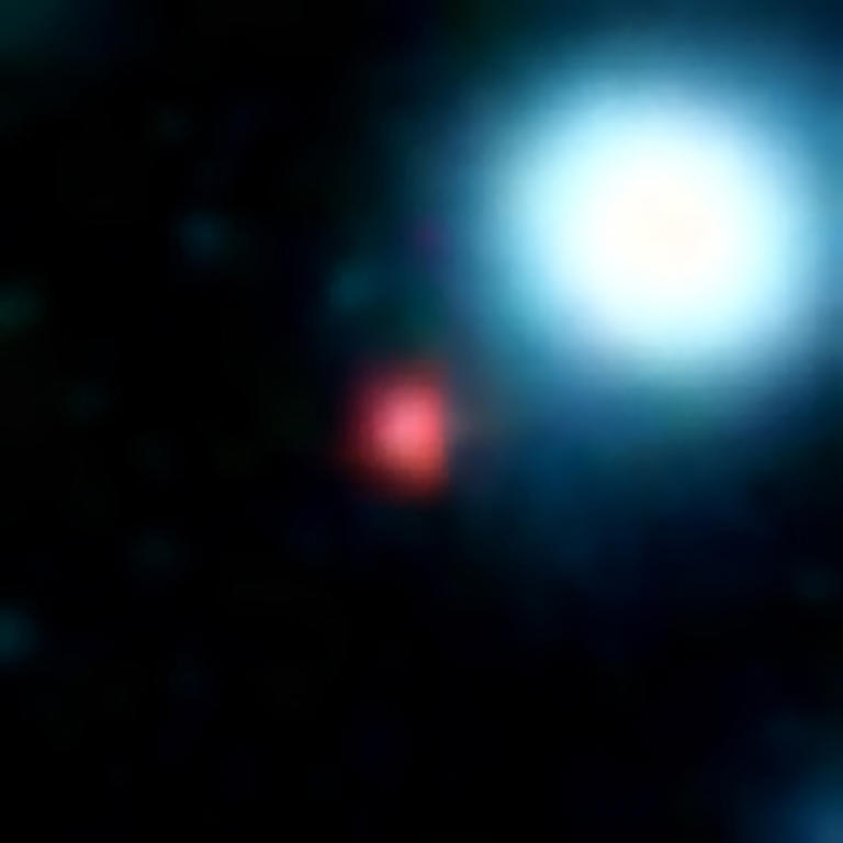 Gaping black hole with flaming red ring spotted in night sky