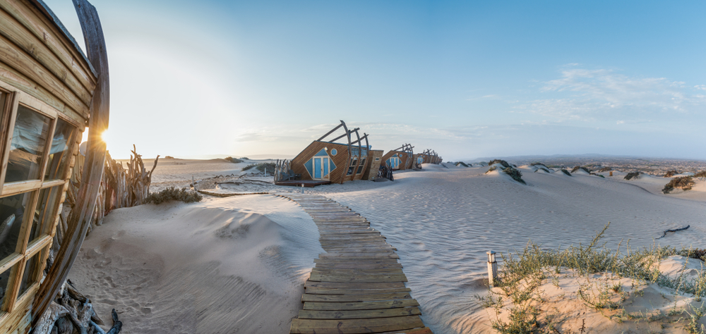 <p>Located in one of <strong>the most remote wilderness destinations in Africa,</strong> this lodge is inspired by the broken, marooned ships that are scattered along the coastline. </p>  <p>The ten suites here are made of wood and glass, and look like they, too, were washed ashore.</p>