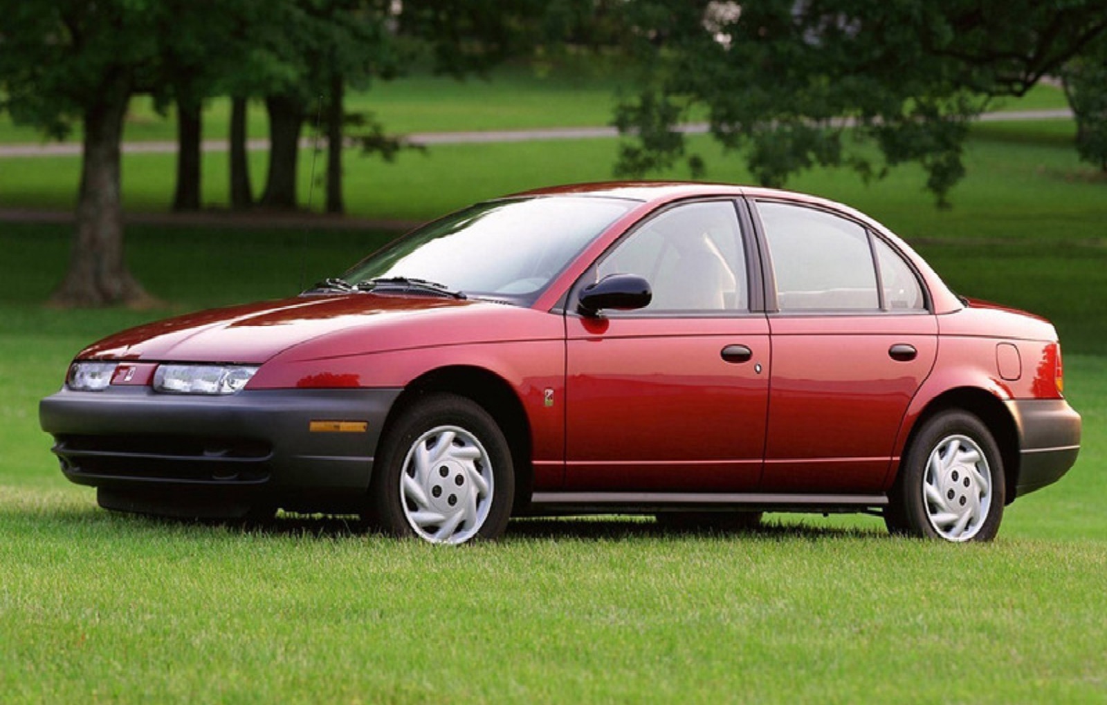 <p>Part of the General Motors family, the Saturn S-Series was notable for its extended <strong>proboscis</strong> front end that hinted at sporting prowess. That was unlikely with the 1.9-litre engine used in the first generation, but it did stand out for using <strong>plastic body panels</strong> hung from a spaceframe-style chassis.</p><p>Saturn also turned out 450 right-hand drive versions in 1999 specifically for the United States Postal Service so the driver could exit on the kerbside for deliveries.</p>