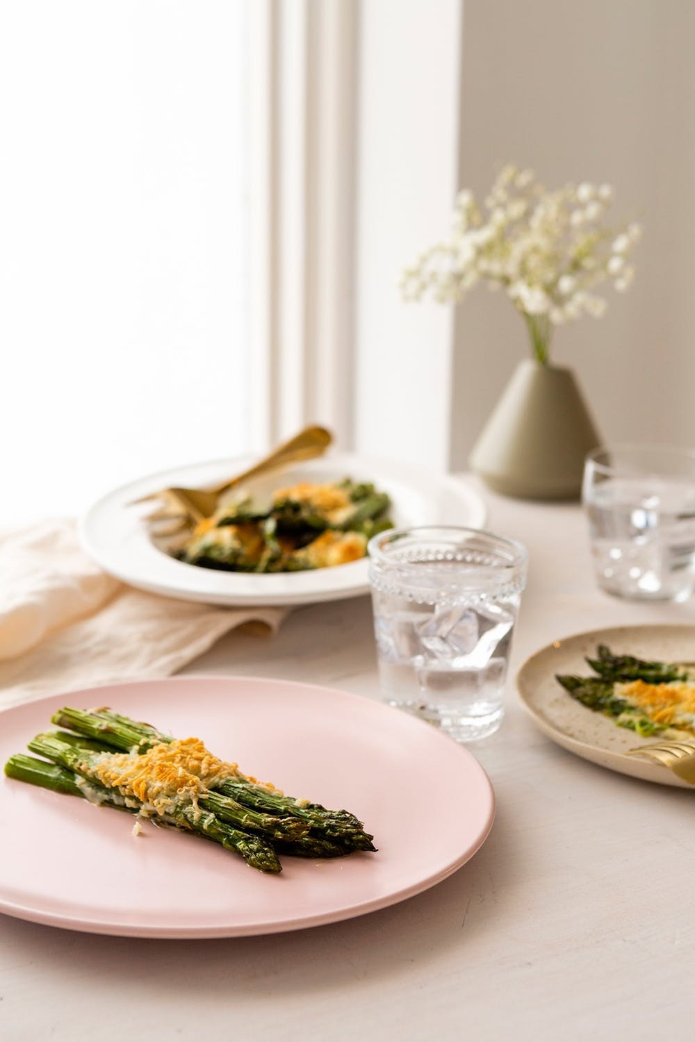 Nothing says spring like asparagus, and we are always down to cover any and every vegetable in cheese. This savory and cheesy combination takes about 20 minutes in the oven. (via Brit + Co.)