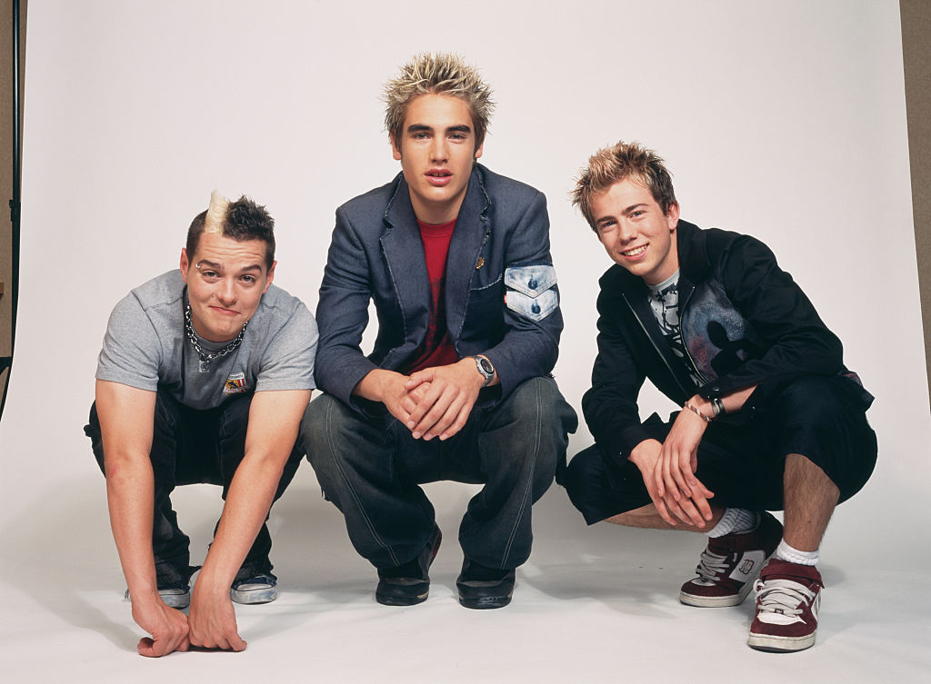 <p>Another notable British boy band for the early 2000s was Busted. They had actually formed themselves and tried to get signed by none other than Simon Cowell but he famously passed on the group. Instead, they set out to release their own debut record and had top singles with "What I Go To School For" and "Year 3000."</p> <p>The three members of Busted claimed to be inspired by pop-punk rock bands like Green Day and Blink-182 which led to the different boy band sound of the 2000s.</p>