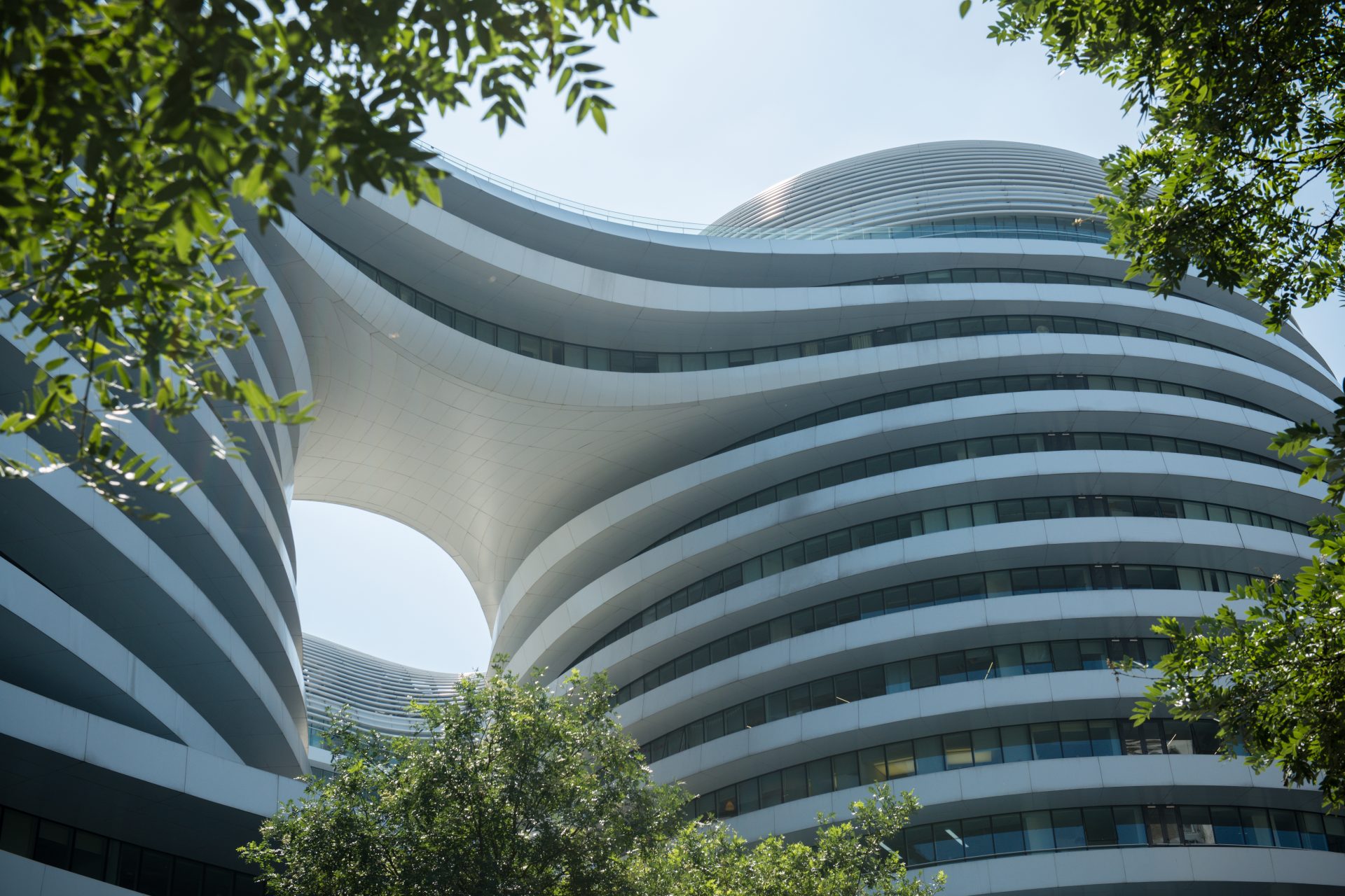 <p>Coexistence with nature can be essential to turn into a positive attitude and restorative happiness. A good example, seen in this image, is the Galaxy Soho building complex in Beijing, China.</p>