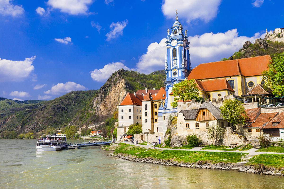 <p>If you're compiling a list of smaller towns and villages to visit along the Danube, you'll want to add Durnstein in Austria's Wachau Valley. This village is home to around 900 residents and looks like something straight out of a storybook, with its crumbling hilltop castle and pretty blue-white church overlooking the river.</p><p>Durnstein is also a must-visit location for wine lovers. This sleepy little town is well-known for its wineries and is surrounded by lush vineyards producing quality Rieslings and other wines. The surrounding countryside is also known for its sweet and plump apricots, whose trees transform the valley's orchards into a fragrant pink-white ocean of blossoms each spring. The locals take these delicious fruits and turn them into a range of products that make excellent souvenirs. Perhaps you'll come home with some apricot liqueurs, marmalades, or even apricot-based cosmetics.</p>