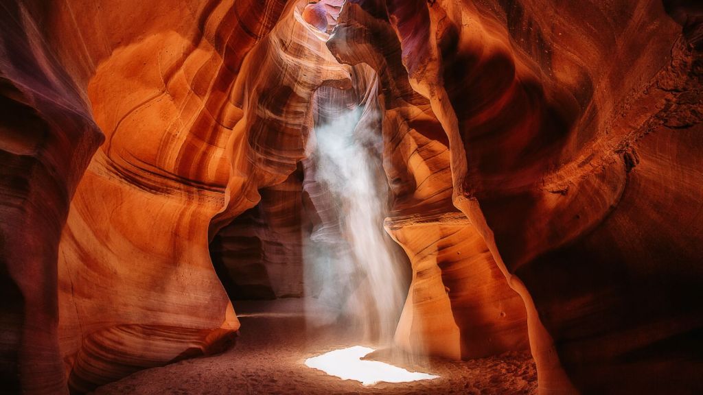 <p>The Antelope Canyon is a work of art and a perfection. The spiraling patterns are so perfect they look almost geometrical. The intricate patterns were carved by centuries of wind and water erosion. </p><p>The interplay of light and shadows only amplifies the beauty of the canyon’s walls. Walk through the narrow passageways of the towering walls as you take in the sunlight rays penetrating through the narrow openings above.  </p><p>Explore the Upper and Lower Antelope Canyons, as they offer different experiences. You also want to spare a huge part of your day exploring this canyon, as the perspectives and lighting during the day shift as the sun rays shift focus. </p><p class="has-text-align-center has-medium-font-size">Read also: <a href="https://worldwildschooling.com/hidden-treasures-in-the-us/">US Hidden Gems</a></p>