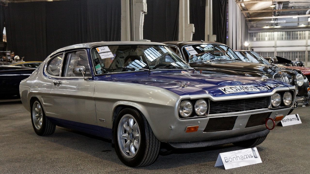 <p>The 1971 Ford Capri RS2600 is a piece of Ford’s European flair, crafted with the spirit of the Mustang in mind but tuned for the European roads. Thanks to Philip T. Clark, one of the Mustang’s designers, the Capri had that fastback coupe vibe down pat. Built on the mechanical bones of the Mk2 Cortina, the Capri was Ford’s way of delivering muscle car excitement to a European audience. The RS2600, with its 2.6-liter fuel-injected engine pushing out 148 bhp, was the cream of the crop, showing off what happens when you blend American muscle with European handling finesse.</p>