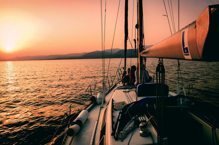 Check out these inspiring destinations across the globe that are great destinations for summer travel. Pictured: a sunset view from a boat overlooking the mountains