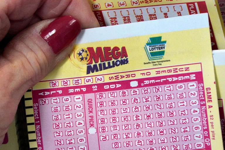 A Mega Millions entry card is displayed at the Cranberry Super Mini Mart in Cranberry, Pa., Thursday, Jan. 12, 2023.