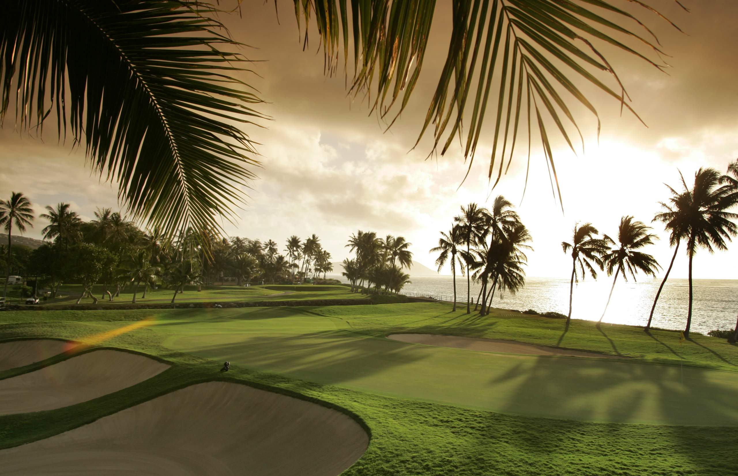 <em><b>Course Location: Honolulu, Hawaii</b></em> In an effort to bring luxury travel and trade to Hawaii, a hotel and golf course were erected on Honolulu's East side. In 1927, a golfing oasis emerged. Helmed by architect Seth Raynor, Waialae Golf Course was built, drawing inspiration from golfing meccas around the globe. The par three 13th is designed from one on the Biarritz Course in France. Meanwhile, the 8th hole pays homage to the iconic Redan Hole of Scotland's North Berwick Course. Venturing further into the course, the unique 16th hole echoes the spirit of the National Course at Southhampton, Long Island. And the 10th Hole introduces features of the 17th or Road Hole at St. Andrews in Scotland. As if a trip to Hawaii wasn't already intriguing enough, a round at Waialae would be the experience of a lifetime.