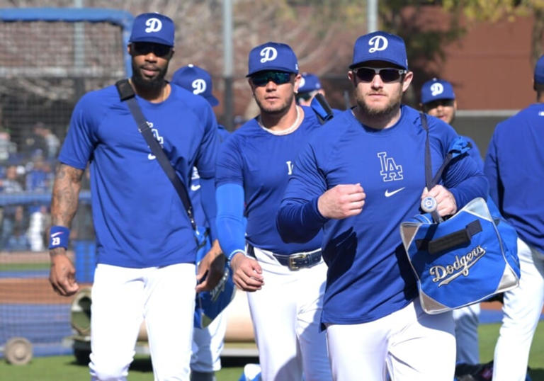Feb 18, 2024; Glendale, AZ, USA; Los Angeles Dodgers third baseman Max Muncy (13), right, is followed by shortstop Miguel Rojas (11) and right fielder Jason Heyward (23) for spring training workouts at Camelback Ranch. Mandatory Credit: Jayne Kamin-Oncea-USA TODAY Sports