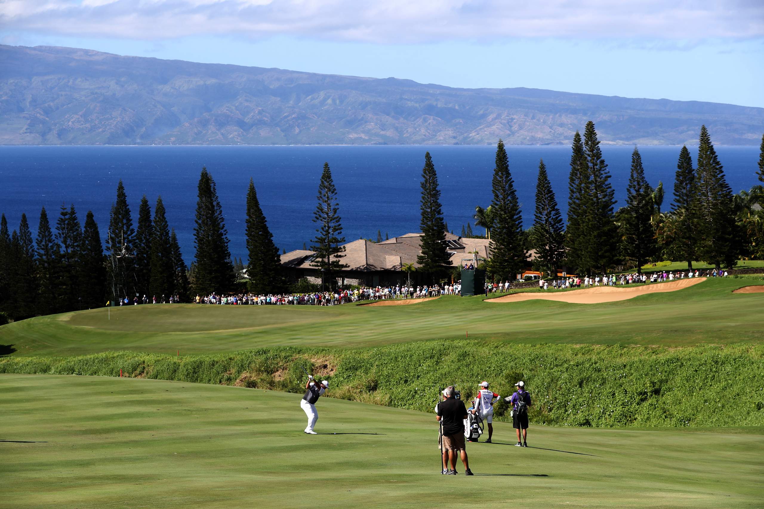 <em><b>Course Location: Lahaina, Hawaii</b></em> Conceived by the esteemed visionaries Ben Crenshaw and Bill Coore, this remarkable course was meticulously crafted to complement its breathtaking setting amidst the undulating slopes of the West Maui Mountains. With sweeping ocean panoramas gracing virtually every hole, the course unfolds as a captivating tapestry of natural beauty and golfing prowess. Spanning an impressive 7,596 yards with a par of 73, it presents a formidable test for even the most seasoned professionals, yet its expansive fairways and inviting greens ensure an accessible and enjoyable experience for golfers of all abilities. As stated before, you really don't need to convince me to go to Hawaii to golf.