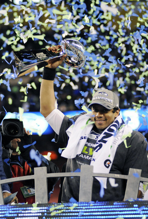 EAST RUTHERFORD, NJ - FEBRUARY 02: Quarterback Russell Wilson #3 of the Seattle Seahawks holding the Lombardi Trophy after they defeated the Denver Broncos in Super Bowl XLVIII on February 2, 2014 at MetLife Stadium in East Rutherford, New Jersey. The Seahawks won the game 43-8. Focus On Sport / Getty Images