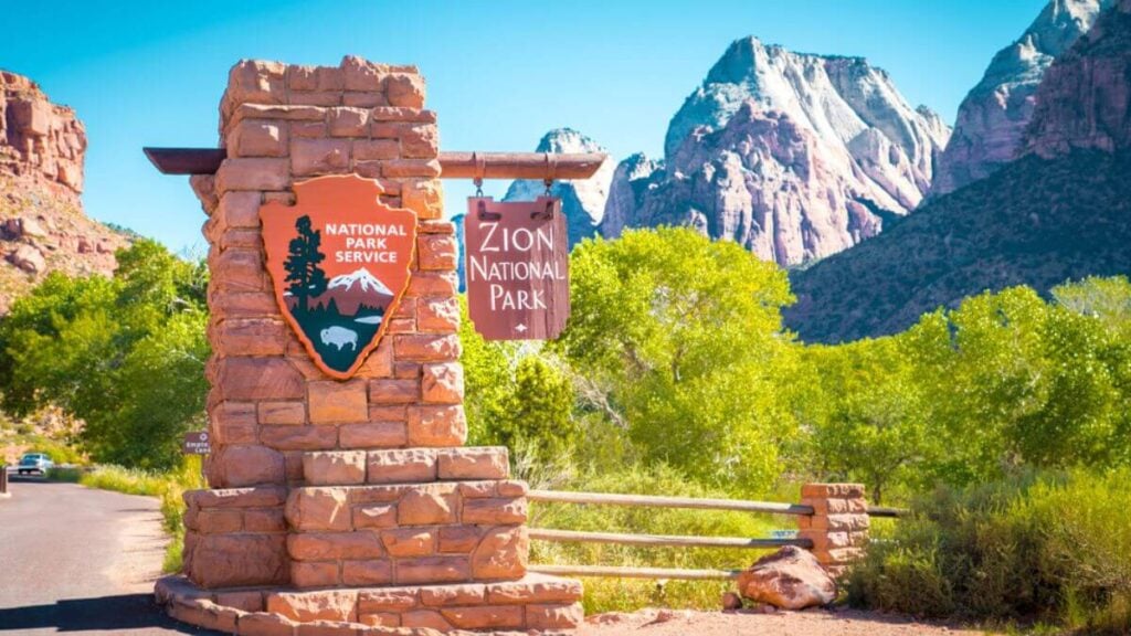 <p>Zion stuns with its towering red cliffs and rich valley floors. Visitors can walk in thin canyons or climb Angel’s Landing to see great views and have fun. The park is home to wildlife, including mule deer and golden eagles. Clear streams run through the canyons, offering spots for visitors to cool off on hot days.</p>