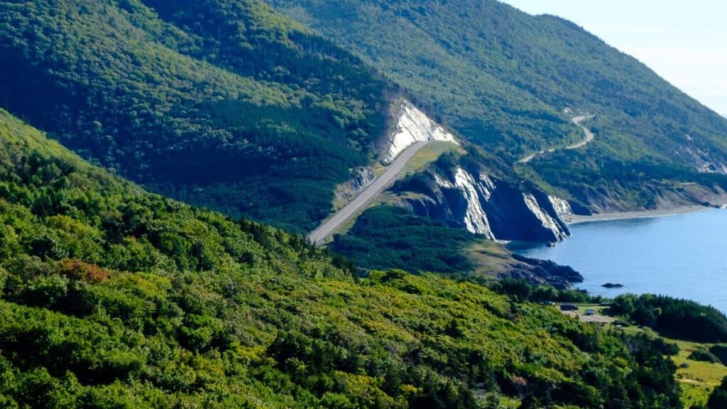<p>The Cabot Trail is an 185-mile circular route in Nova Scotia, Canada. It features rough coastlines, countryside valleys, and the high areas of Cape Breton Island. This route features stunning seascapes and opportunities to spot whales, bald eagles, and maybe even a moose.</p>