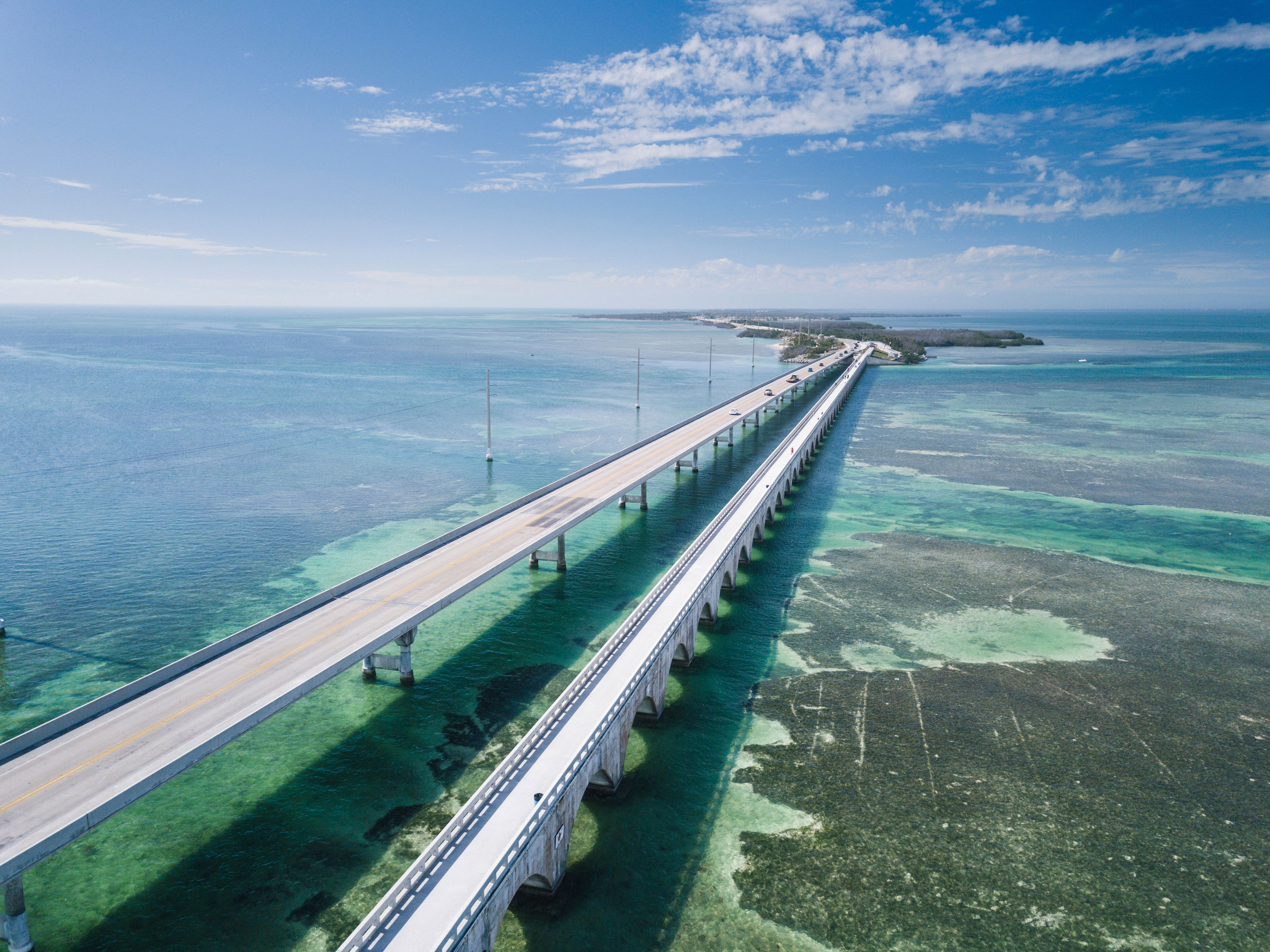 <p>Driving down the Overseas Highway from <a href="https://www.cntraveler.com/destinations/miami?mbid=synd_msn_rss&utm_source=msn&utm_medium=syndication">Miami</a> to <a href="https://www.cntraveler.com/destinations/key-west?mbid=synd_msn_rss&utm_source=msn&utm_medium=syndication">Key West</a> feels like slowly decompressing from the world at large. (The Seven Mile Bridge will make you feel like you’re soaring over the water.) The necklace of islands strung together by this 127.5-mile road vary markedly, moving from the Upper Keys, which seem like shards of the mainland cast off into the ocean, on to the Middle and Lower Keys. The final stop is Key West, a.k.a the Conch Republic. The journey only takes four hours total (though watch for delays, as traffic accidents can block the road and make passing impossible). If you can, earmark a week to meander down and explore hidden corners at your own pace.</p> <p><strong>Where to stop:</strong> Press on through the Upper Keys, which can feel a little gimmicky thanks to an abundance of souvenir shops, and instead linger in the Middle and Lower Keys en route to Key West. Go spearfishing near Marathon with one of the local fishing charters or sunbathe in the wilderness of <a href="https://bahiahondapark.com/">Bahia Honda State Park</a>, one of the prettiest spots in the Keys. Sandy beaches are rare elsewhere on the archipelago, but you’ll find several here. Finally, in Key West, take a refreshing, well-deserved dip at <a href="https://www.floridastateparks.org/parks-and-trails/fort-zachary-taylor-historic-state-park">Fort Zachary State Park.</a> A great plus: there’s music everywhere– so as long as you're strolling, you’ll get your groove on.</p> <p><strong>Where to eat:</strong> You’re going to want to try Key Lime Pie in its spiritual home—debates rage as to the best, but we’d start with a slice at <a href="https://blueheavenkw.com/">Blue Heaven</a>, an al fresco restaurant with a yard full of roosters—but don’t miss the chance to detour for a pizza and a pint at the <a href="https://nonamepub.com/">No Name Pub</a>. Located on a hard-to-find island where Cuban patriots staged rehearsals for the Bay of Pigs invasion, the pub’s interior is covered with currency stapled to almost every surface. Ask to borrow the staple gun if you want to add to your own.</p> <p><strong>Where to stay:</strong> Key West is surprisingly large, and much of the <a href="https://www.cntraveler.com/gallery/best-hotels-in-key-west?mbid=synd_msn_rss&utm_source=msn&utm_medium=syndication">accommodations</a> are clustered around the eastern edges—avoid this at all costs, as it’s a long hike from the main drag on Duval. Instead, splurge for one of the 19th-century cottages at <a href="https://www.kimptonkeywest.com/key-west-hotels/winslows-bungalows/">Winslow’s Bungalows</a> downtown, or at <a href="https://www.cntraveler.com/hotels/the-perry-hotel-key-west?mbid=synd_msn_rss&utm_source=msn&utm_medium=syndication">The Perry Hotel</a> for a more chic and spacious vibe. If preferred, there are some great <a href="https://www.cntraveler.com/gallery/best-key-west-airbnbs-and-vacation-rentals?mbid=synd_msn_rss&utm_source=msn&utm_medium=syndication">Airbnb recommendations</a> available to book as well.</p><p>Sign up to receive the latest news, expert tips, and inspiration on all things travel</p><a href="https://www.cntraveler.com/newsletter/the-daily?sourceCode=msnsend">Inspire Me</a>
