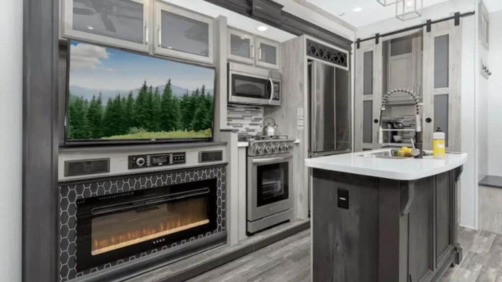 <p>Two entrances, an outdoor kitchen, and dual tri-fold sofa sleepers in the living room make the Alpine 5th wheel an ideal choice for family RV camping. The living area also boasts two slideouts, theater seating, and a free-standing dinette.</p><p>A direct entrance into the kitchen makes it easy to host holiday gatherings in your RV, especially if you upgrade from the standard 18-cubic-foot gas/electric refrigerator to the residential refrigerator with an ice maker.</p><p>Some of the other noticeable features we love about this model include a <a href="https://www.thewaywardhome.com/travel-trailer-with-king-bed/">king bed</a> in the master suite, washer-dryer prep in the front bath, dual Quiet Cool A/C units, and 4G LTE and Wi-Fi prep.</p>