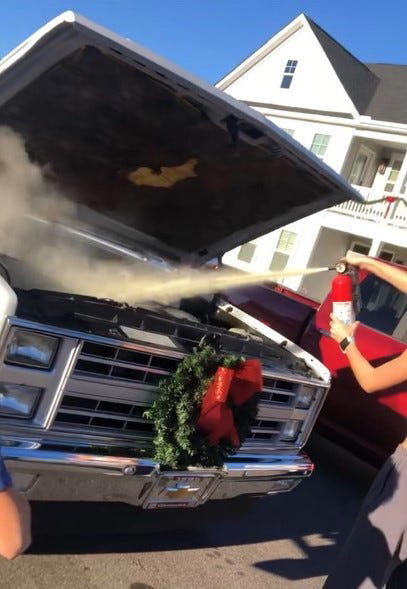 Topsail High School student Jillian Lombardo puts out a fire that started under the hood of her brother Will's truck. Lombardo was able to act quickly because of the fire safety lessons she learned in her public safety class.