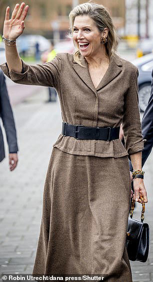 Queen Maxima beams as she steps out in Zwolle wearing chic brown suit ...