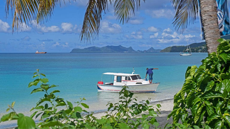 A small fishing boat anchored at Paradise Beach on Carriacou. A retired British couple were mysteriously found dead on the beach on Saturday. Marica van der Meer/Arterra/Universal Images Group via Getty Images