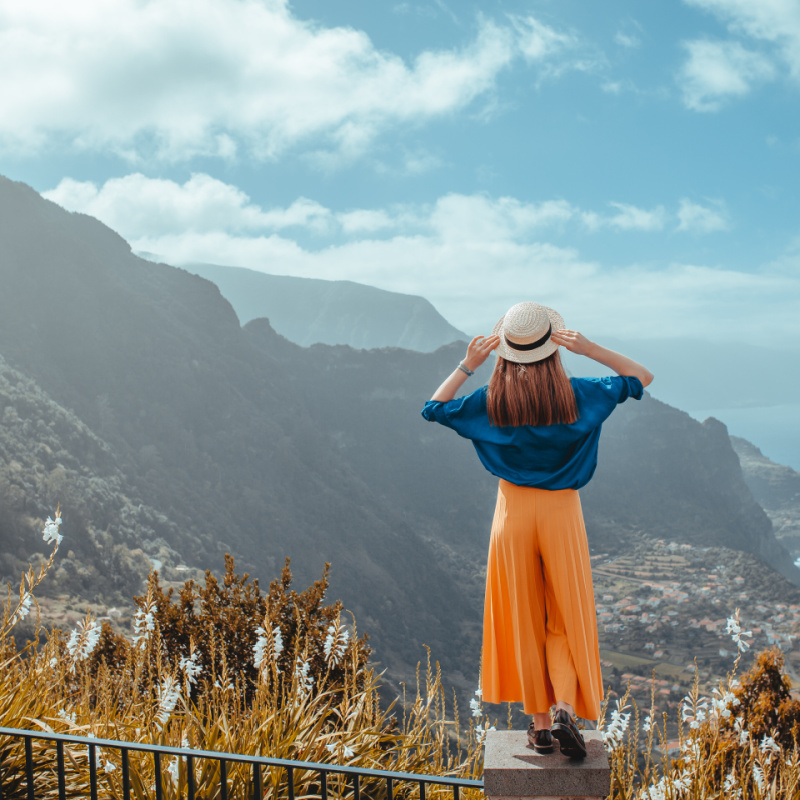 solo female traveler looks out at amazing view in madeira