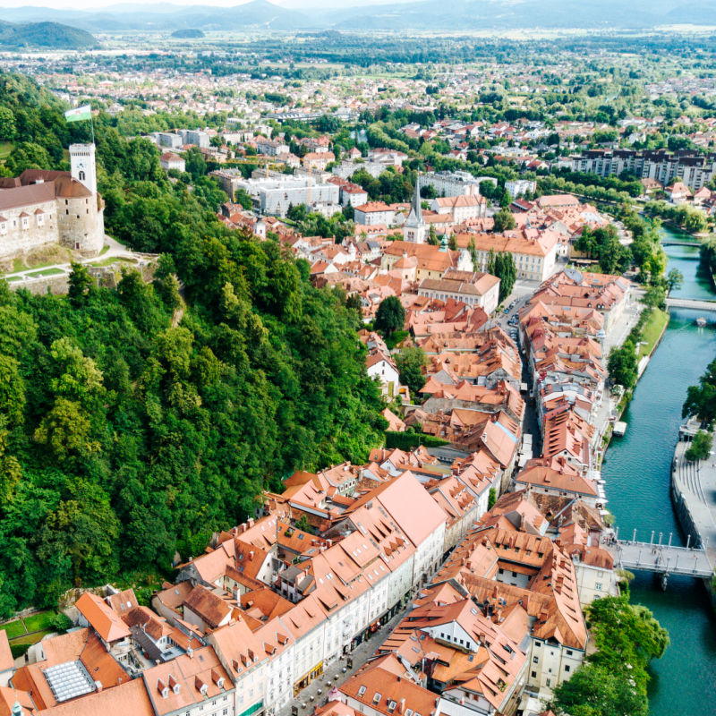 aerial view of ljubljana in slovenia showing river and castle on the hill surrounded by trees